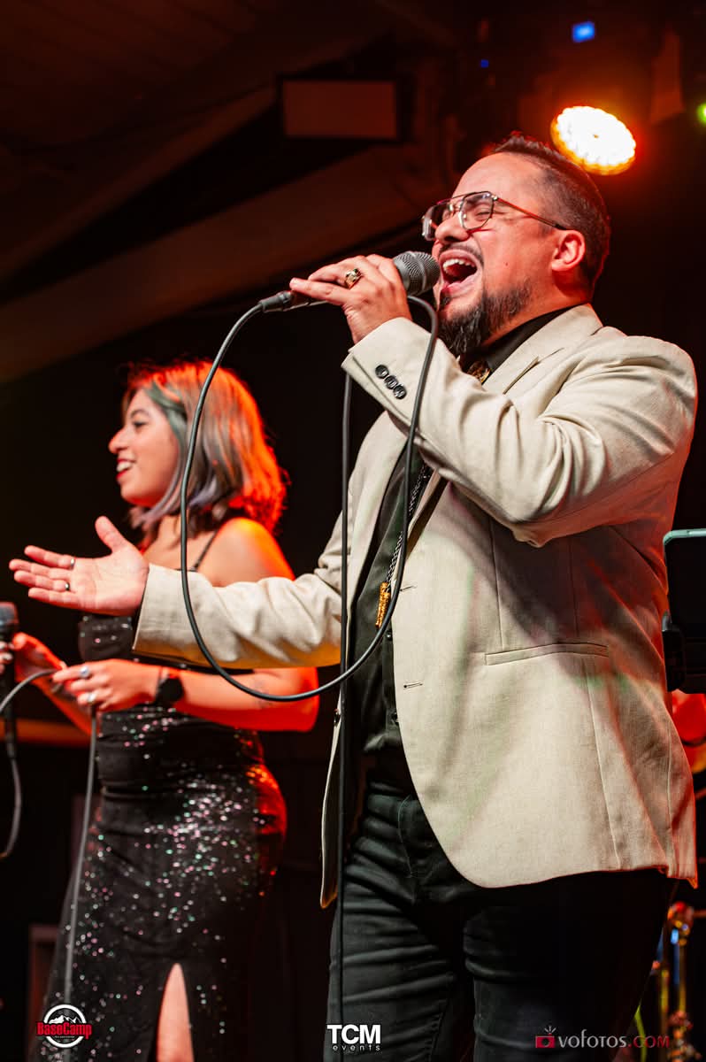 Lead vocalist and female vocalist sharing the stage mid-song